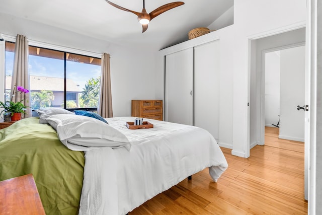 bedroom with ceiling fan, vaulted ceiling, and light hardwood / wood-style flooring