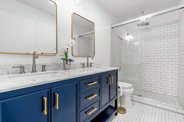 bathroom with tile patterned floors, vanity, toilet, and an enclosed shower