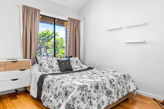 bedroom with wood-type flooring