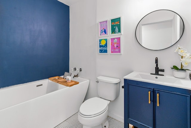 bathroom featuring tile patterned flooring, vanity, toilet, and a tub