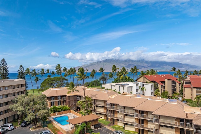 birds eye view of property with a water and mountain view