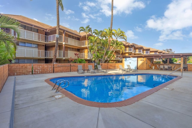 view of pool featuring an outdoor bar and a patio