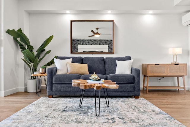 living room featuring hardwood / wood-style floors and ceiling fan