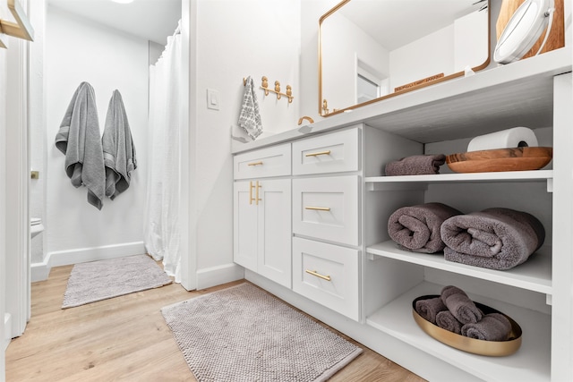 bathroom featuring toilet and hardwood / wood-style flooring