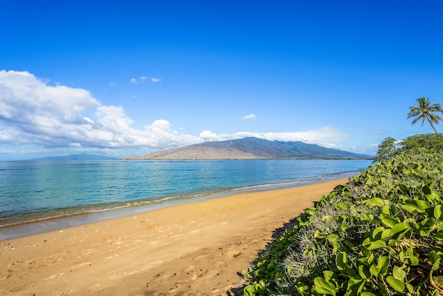 water view featuring a beach view and a mountain view