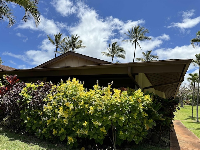 view of home's exterior featuring board and batten siding and a lawn