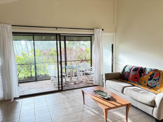 living area featuring tile patterned flooring and a high ceiling