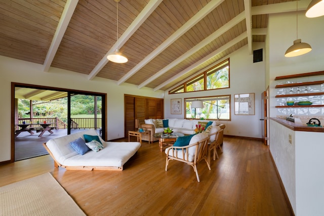 living room featuring plenty of natural light, wood-type flooring, and high vaulted ceiling