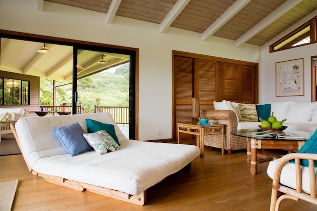 interior space featuring hardwood / wood-style flooring, wooden ceiling, vaulted ceiling with beams, and access to outside