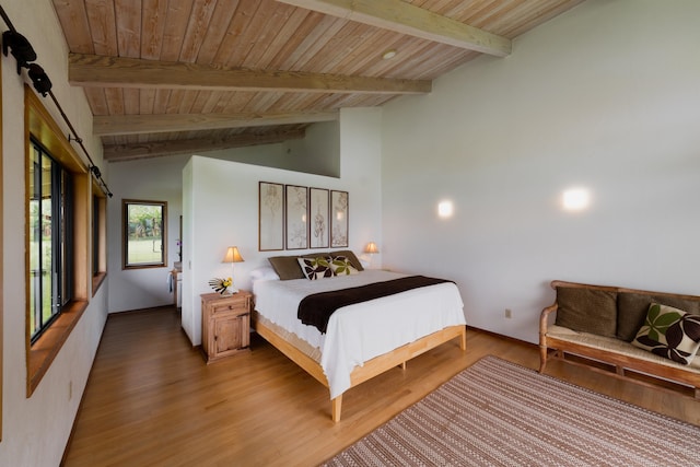 bedroom featuring wooden ceiling, hardwood / wood-style flooring, and a barn door