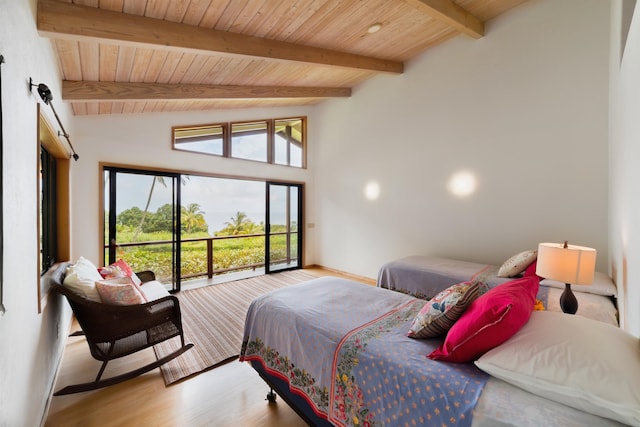 bedroom with lofted ceiling with beams, multiple windows, hardwood / wood-style floors, and wood ceiling