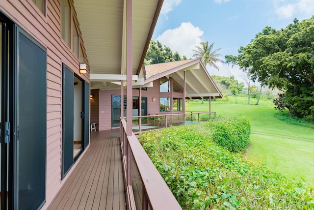 wooden deck featuring a yard