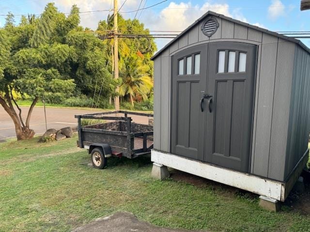 view of outbuilding with a yard