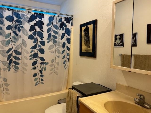 full bathroom with vanity, toilet, and shower / bath combo with shower curtain