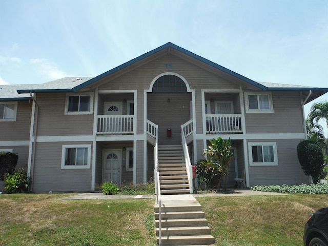view of front of home featuring a front yard and stairway