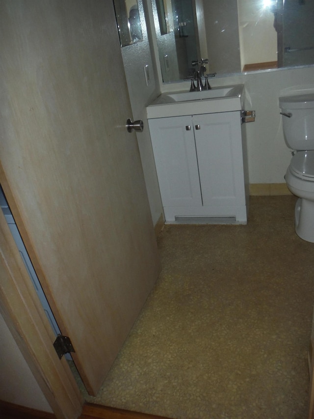bathroom featuring toilet and vanity