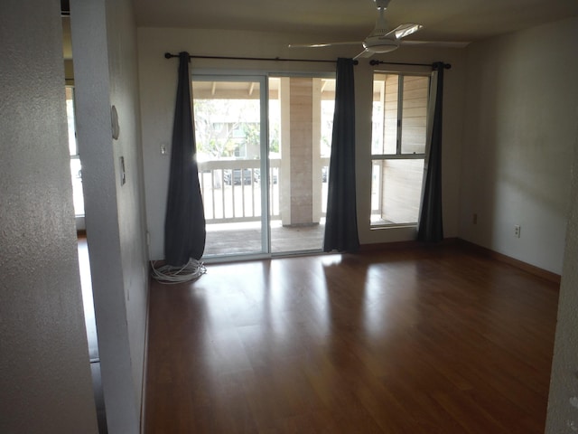 unfurnished room with wood finished floors and a ceiling fan