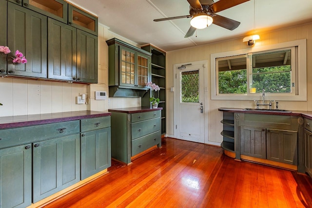 kitchen featuring dark wood-type flooring, ceiling fan, and sink