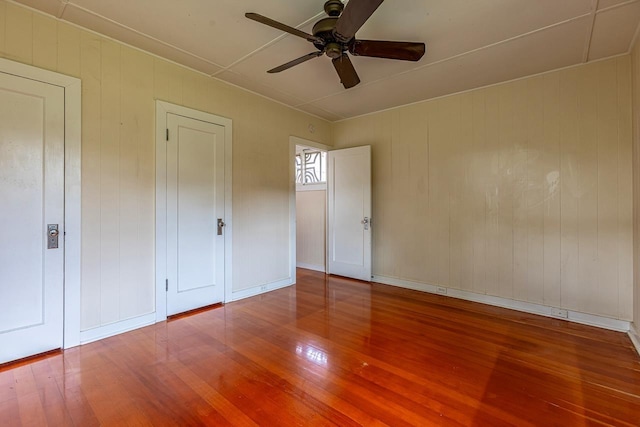 unfurnished bedroom with hardwood / wood-style floors and ceiling fan