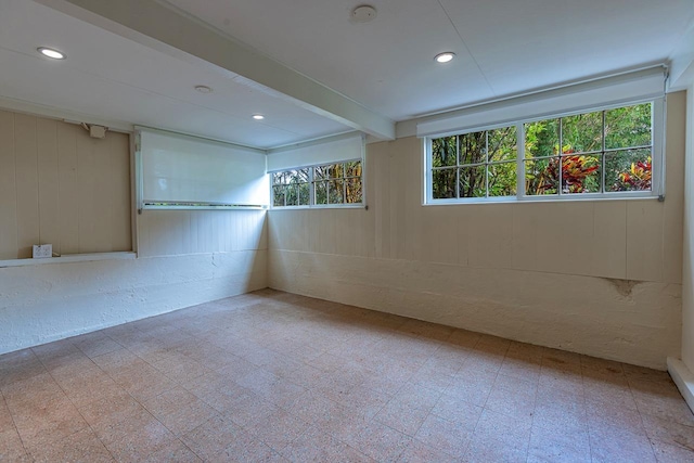 spare room with beamed ceiling