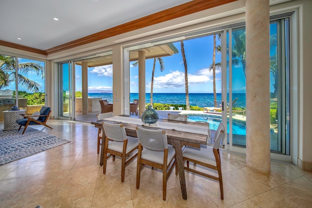 dining space with ornamental molding, a water view, and light tile patterned floors