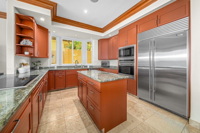 kitchen with black appliances, ornamental molding, sink, a center island, and a raised ceiling