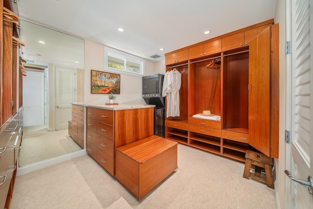 walk in closet featuring light carpet