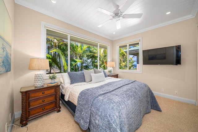 carpeted bedroom with ornamental molding and ceiling fan