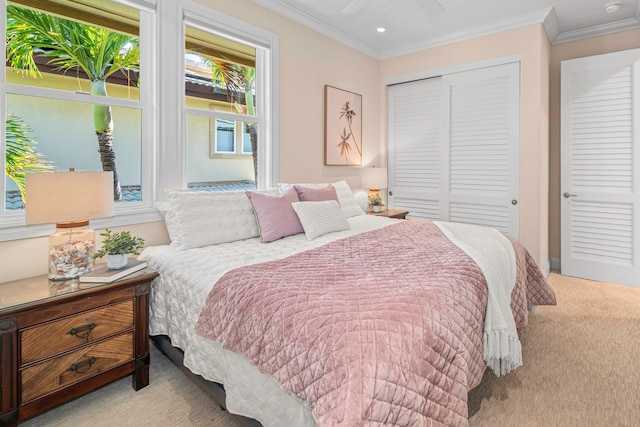 bedroom featuring light carpet, crown molding, and a closet