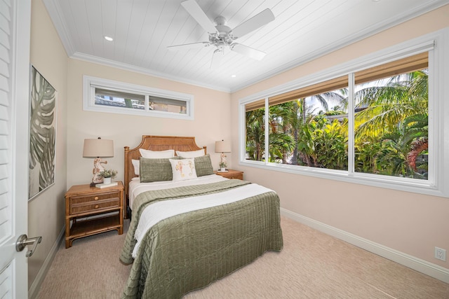 bedroom featuring multiple windows, ornamental molding, carpet floors, and ceiling fan