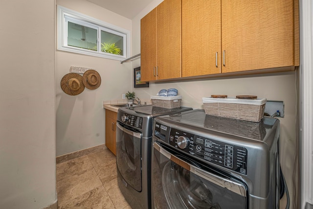 laundry area with light tile patterned floors, independent washer and dryer, sink, and cabinets