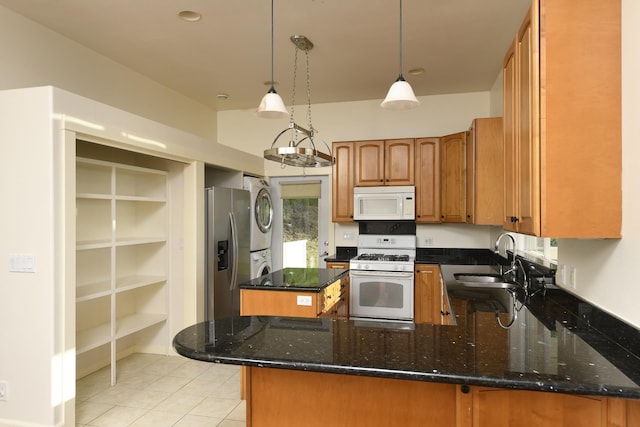210 Napoko Pl, Kula, HI 96790 - kitchen with white appliances, stacked washer / dryer, a sink, and dark stone countertops