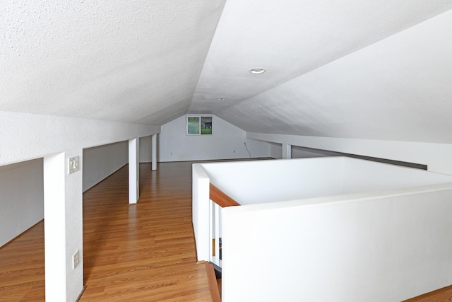 210 Napoko Pl, Kula, HI 96790 - additional living space with vaulted ceiling, light wood finished floors, and a textured ceiling