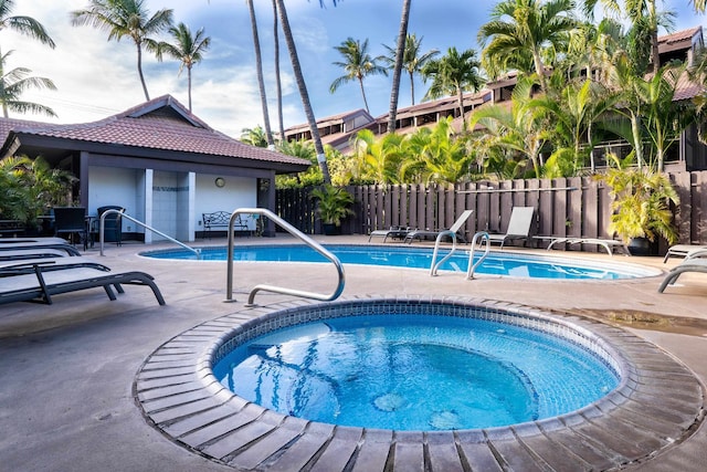 view of swimming pool with a patio and an in ground hot tub