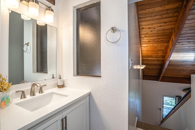 bathroom with vaulted ceiling with beams, wood ceiling, and vanity