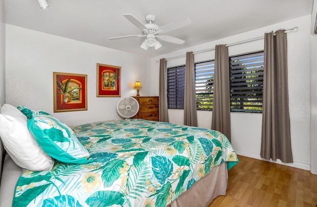 bedroom with wood-type flooring and ceiling fan