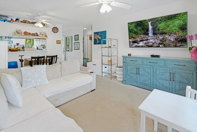 carpeted living room with ceiling fan