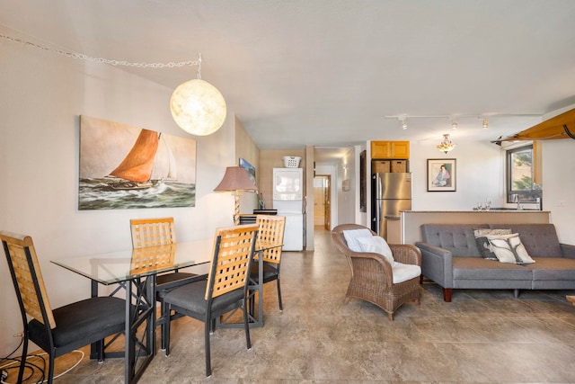 dining area featuring rail lighting