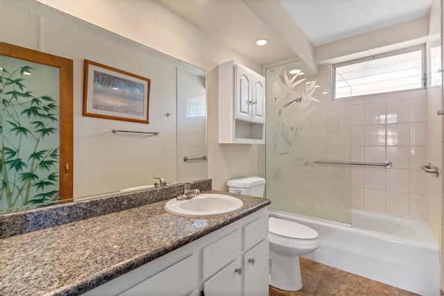 full bathroom featuring tiled shower / bath, vanity, and toilet