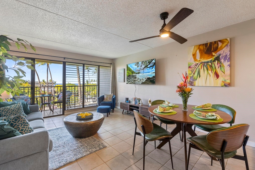 interior space with ceiling fan and a textured ceiling