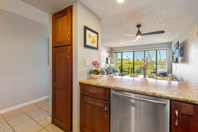 kitchen featuring light stone counters, a textured ceiling, dishwasher, and light tile patterned flooring