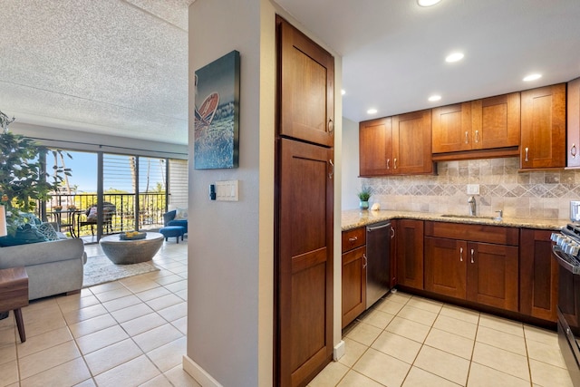 kitchen with sink, light tile patterned floors, dishwasher, and backsplash