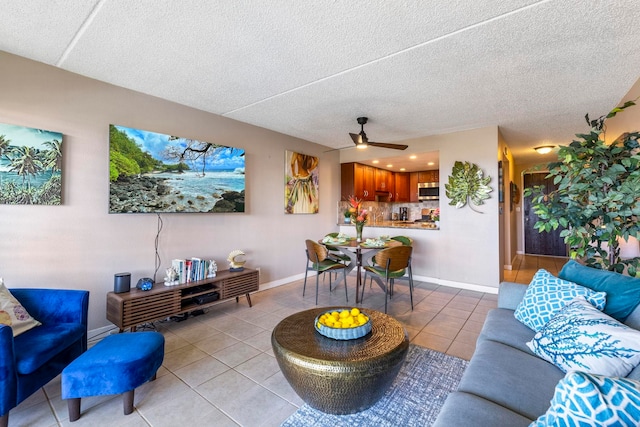 living room with light tile patterned floors, a textured ceiling, and ceiling fan