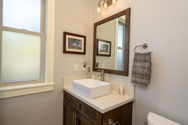 bathroom with toilet and vanity