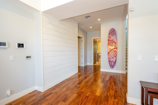 corridor with recessed lighting, wood finished floors, visible vents, and baseboards