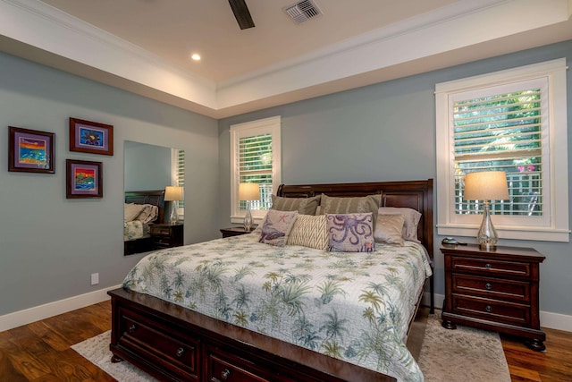 bedroom featuring crown molding, dark wood-style floors, visible vents, and baseboards