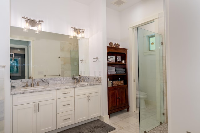 bathroom featuring a sink, visible vents, a stall shower, and double vanity