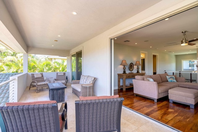view of patio featuring an outdoor living space, visible vents, and a ceiling fan