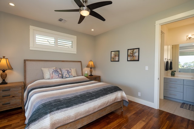 bedroom with baseboards, multiple windows, visible vents, and wood finished floors