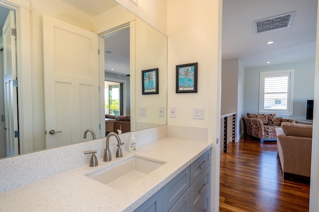 bathroom with recessed lighting, visible vents, plenty of natural light, and wood finished floors